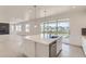 Bright, modern kitchen features quartz countertops, stainless appliances, and access to the outdoor deck at 2525 Lupton Ln, Lafayette, CO 80026