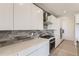 Modern kitchen features quartz countertops, stainless steel appliances, and sleek grey backsplash at 2525 Lupton Ln, Lafayette, CO 80026