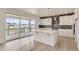 Open kitchen with island, modern cabinets, stainless steel appliances, and sliding glass doors to the deck at 2525 Lupton Ln, Lafayette, CO 80026