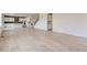 Open floor plan with light hardwood floors and view to the kitchen and stairway at 2525 Lupton Ln, Lafayette, CO 80026