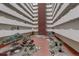 Indoor atrium with greenery and seating areas in the center of the condo building at 3131 E Alameda Ave # 1003, Denver, CO 80209