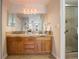 Updated bathroom featuring a double sink vanity with granite counters and tiled shower at 3131 E Alameda Ave # 1003, Denver, CO 80209
