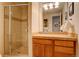 Neutral bathroom features a tiled shower with glass doors, plus single sink vanity at 3131 E Alameda Ave # 1003, Denver, CO 80209
