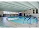 Bright indoor pool with stairs and beautiful tile and a big window with a view at 3131 E Alameda Ave # 1003, Denver, CO 80209