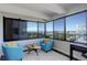 Bright sunroom featuring floor-to-ceiling windows with city and mountain views at 3131 E Alameda Ave # 1003, Denver, CO 80209