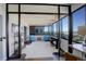 Open sunroom with floor-to-ceiling windows and city and mountain views at 3131 E Alameda Ave # 1003, Denver, CO 80209