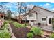 Beautiful backyard with a deck, garden, and grey siding on the house at 21733 Saddlebrook Dr, Parker, CO 80138