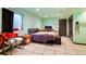Cozy basement bedroom with desk, tiled floors, and a door leading to additional space at 21733 Saddlebrook Dr, Parker, CO 80138