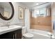 Cozy bathroom featuring a tub/shower combination with a window, vanity, and framed artwork at 21733 Saddlebrook Dr, Parker, CO 80138