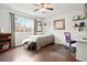 Bright bedroom with hardwood floors, a large window, and a dedicated workspace at 21733 Saddlebrook Dr, Parker, CO 80138