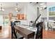 Bright dining area seamlessly connected to the kitchen, with hardwood floors and a view of the landscaped backyard at 21733 Saddlebrook Dr, Parker, CO 80138