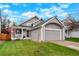 Charming two-story home with a well-manicured lawn, gray siding, and a front porch perfect for relaxing at 21733 Saddlebrook Dr, Parker, CO 80138