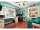 Bright home office with hardwood floors, built-in shelving, large window, and an expansive desk at 21733 Saddlebrook Dr, Parker, CO 80138