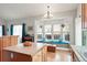 Bright kitchen with wood cabinets, an island, and a charming window seat overlooking the backyard, perfect for casual dining at 21733 Saddlebrook Dr, Parker, CO 80138