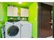 Laundry room with a washer, dryer, shelving, and upper cabinets at 21733 Saddlebrook Dr, Parker, CO 80138