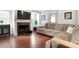 Cozy living room with hardwood floors, a fireplace with marble tile, and a comfortable sectional sofa for relaxing at 21733 Saddlebrook Dr, Parker, CO 80138