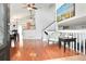 Bright, open-concept living area with hardwood floors, high ceilings, and seamless transition to dining and kitchen spaces at 21733 Saddlebrook Dr, Parker, CO 80138