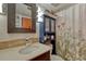 Cozy bathroom features vanity with modern faucet, blue storage cabinet, and floral shower curtain at 1243 Gaylord St # 410, Denver, CO 80206