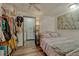 Charming bedroom boasts hardwood floors, closet space, and delightful painting over comfy bed at 1243 Gaylord St # 410, Denver, CO 80206