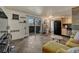 Open living space with a comfortable yellow sofa, tile floors, and a sliding glass door to a balcony at 1243 Gaylord St # 410, Denver, CO 80206