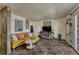 Cozy living room featuring unique tile floors, a comfortable yellow sofa, and ample natural light at 1243 Gaylord St # 410, Denver, CO 80206