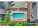 Aerial view of a community pool with lounge chairs and manicured landscaping at 1243 Gaylord St # 410, Denver, CO 80206