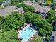 Community pool surrounded by trees and multi-Gathering apartments, offering a luxurious retreat at 2428 W 82Nd Pl # 1D, Westminster, CO 80031