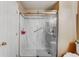 Modern bathroom features a sleek glass-enclosed shower with a marbled surround, grab bar, and updated fixtures at 2428 W 82Nd Pl # 1D, Westminster, CO 80031