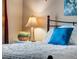 Inviting bedroom featuring a decorative lamp, pillow, and throw on the bed at 2428 W 82Nd Pl # 1D, Westminster, CO 80031