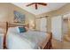 Cozy bedroom featuring a decorative bed frame, modern barn door and ceiling fan for a comfortable and stylish space at 2428 W 82Nd Pl # 1D, Westminster, CO 80031