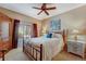 A bedroom with a ceiling fan and a comfortable bed with decorative pillows and stylish side tables at 2428 W 82Nd Pl # 1D, Westminster, CO 80031