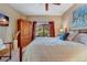 Charming bedroom features a wrought iron bed frame, a ceiling fan, and ample natural light from the window at 2428 W 82Nd Pl # 1D, Westminster, CO 80031