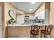 Bright kitchen features a breakfast bar with quartz countertops and stainless steel appliances at 2428 W 82Nd Pl # 1D, Westminster, CO 80031