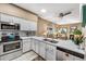 Well-lit kitchen with quartz countertops, stainless steel appliances and open floor plan at 2428 W 82Nd Pl # 1D, Westminster, CO 80031