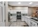 Bright kitchen with white cabinets, stainless steel appliances, and a modern backsplash at 2428 W 82Nd Pl # 1D, Westminster, CO 80031