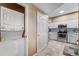 Convenient laundry area with stacked washer and dryer near the kitchen, maximizing space and functionality at 2428 W 82Nd Pl # 1D, Westminster, CO 80031