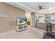 Open-concept living space features a large TV, neutral walls, and ceiling fan for comfort and modern living at 2428 W 82Nd Pl # 1D, Westminster, CO 80031