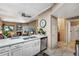 Open floor plan with kitchen view into living room with fireplace and a connecting doorway at 2428 W 82Nd Pl # 1D, Westminster, CO 80031