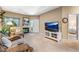 Inviting living room features a cozy fireplace, plush seating, and a modern entertainment center with a large screen TV at 2428 W 82Nd Pl # 1D, Westminster, CO 80031