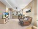 Bright living area with open access to the kitchen, modern appliances, bar seating, and comfortable recliner chair at 2428 W 82Nd Pl # 1D, Westminster, CO 80031