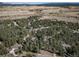 Aerial view of the property showcasing surrounding homes and trees at 8174 Inca Rd, Larkspur, CO 80118