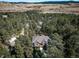 Aerial view of a house nestled in a wooded area at 8174 Inca Rd, Larkspur, CO 80118