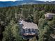 House with large deck, nestled in a wooded, mountainous area at 8174 Inca Rd, Larkspur, CO 80118
