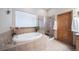 Bathroom with soaking tub and walk-in shower at 8174 Inca Rd, Larkspur, CO 80118