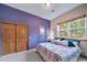 Spacious bedroom with wood doors and a large window at 8174 Inca Rd, Larkspur, CO 80118