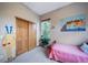 Bright bedroom with a twin bed and whimsical wall art at 8174 Inca Rd, Larkspur, CO 80118