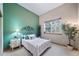 Cozy bedroom with a white bed frame and leafy plant at 8174 Inca Rd, Larkspur, CO 80118