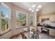 Dining area with views of treelined landscape and study nook with granite counters at 8174 Inca Rd, Larkspur, CO 80118
