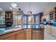 Kitchen features granite island, ample cabinetry, and corner sink at 8174 Inca Rd, Larkspur, CO 80118