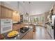 Bright kitchen featuring stainless steel appliances, an island cooktop, and views of the outdoor scenery at 8174 Inca Rd, Larkspur, CO 80118
